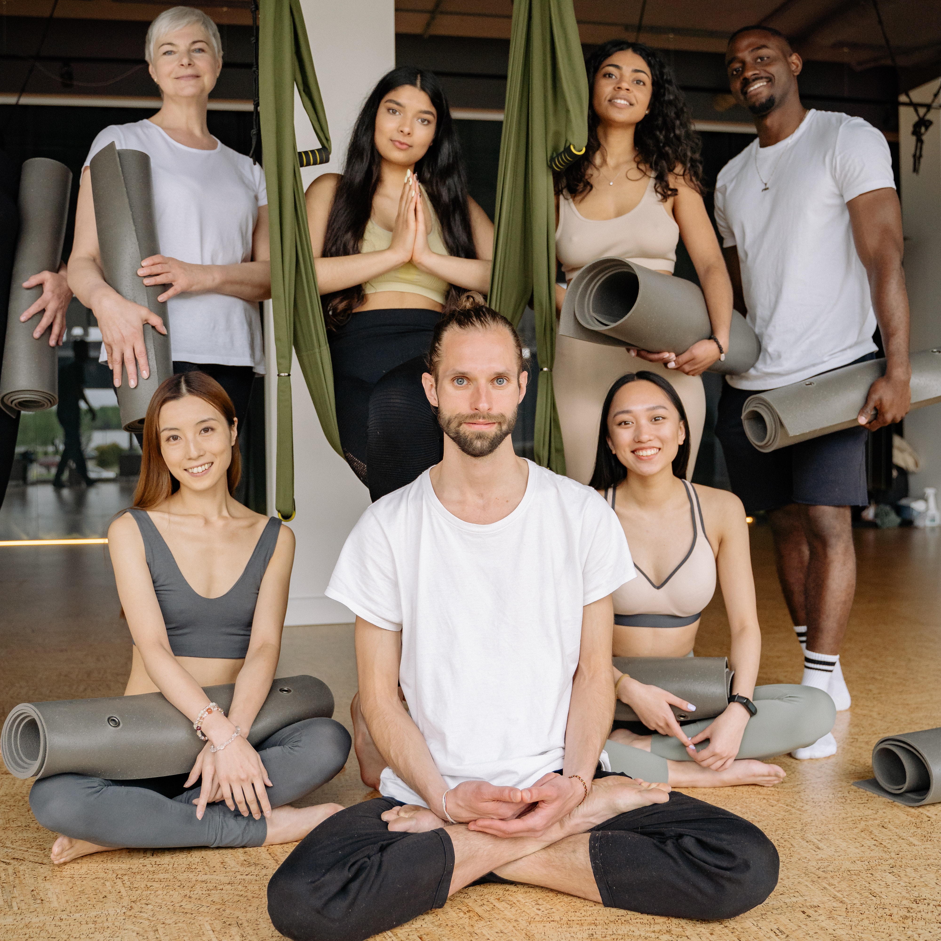 a yoga team similing and posing for the camera